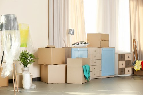 Removal team handling furniture in a Charlton flat